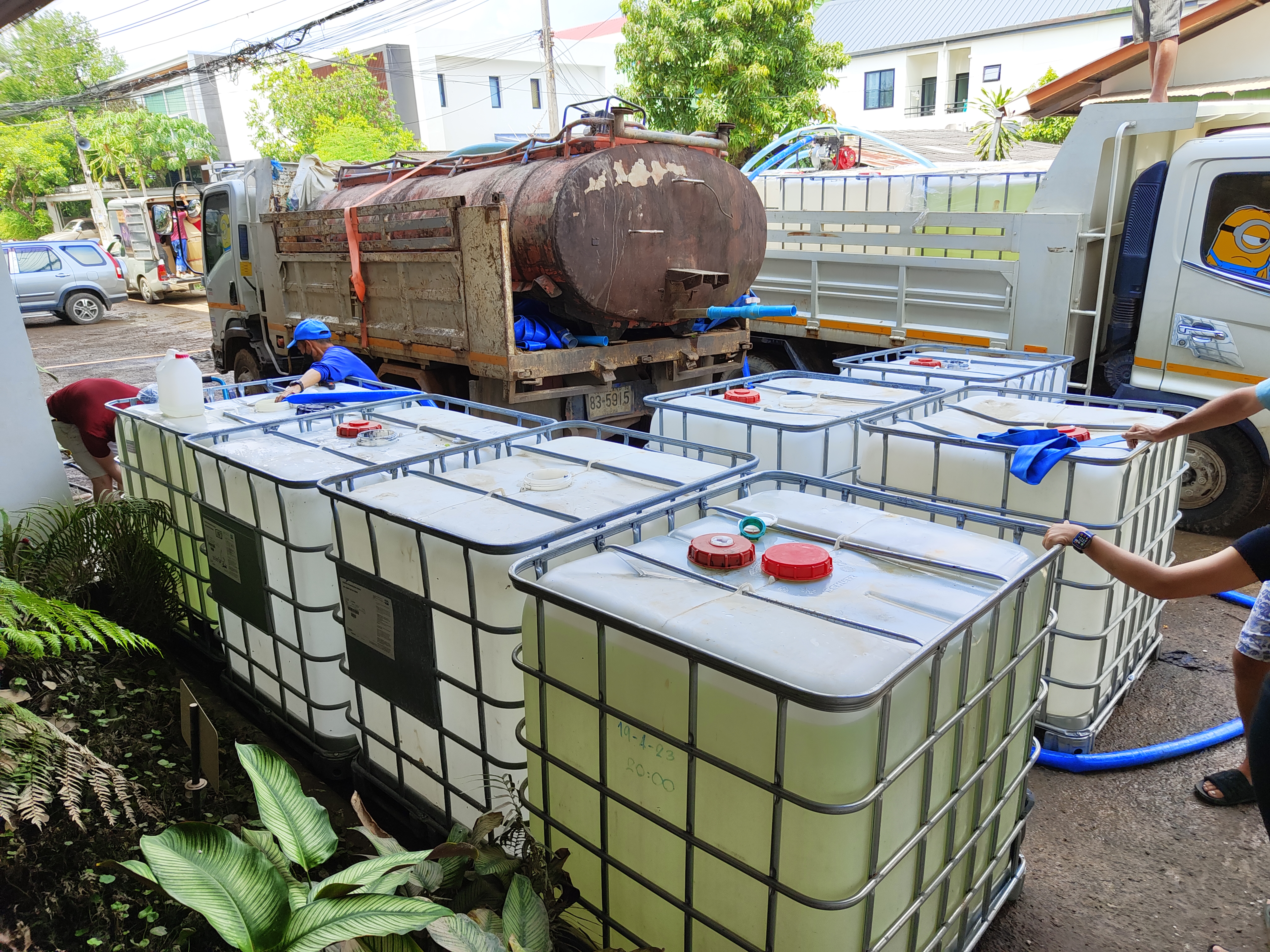 IBC tanks being filled from water truck