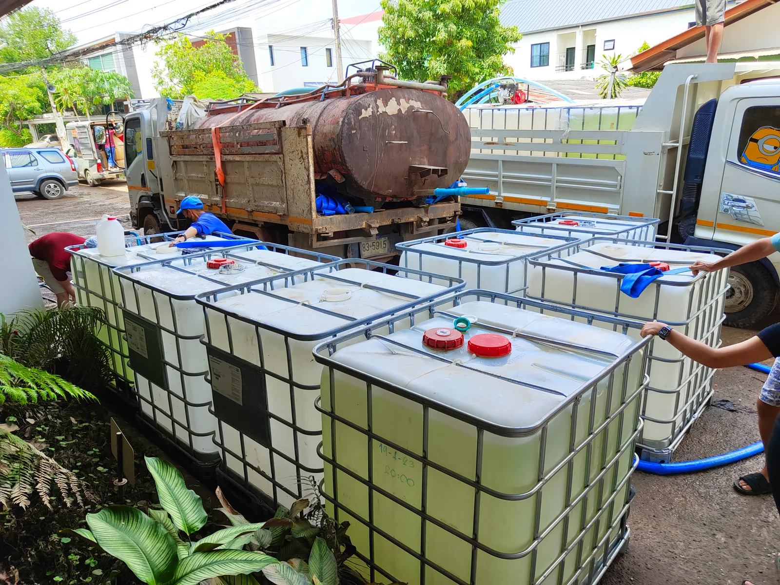 IBC tanks being filled from water truck