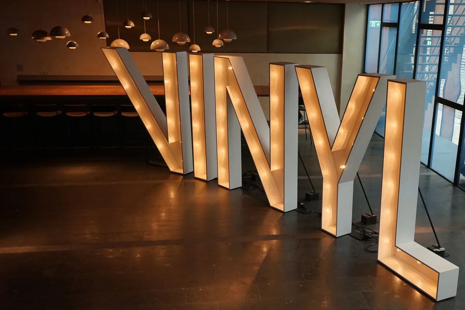 The lit VINYL letters in the foyer of PHIL Haarlem